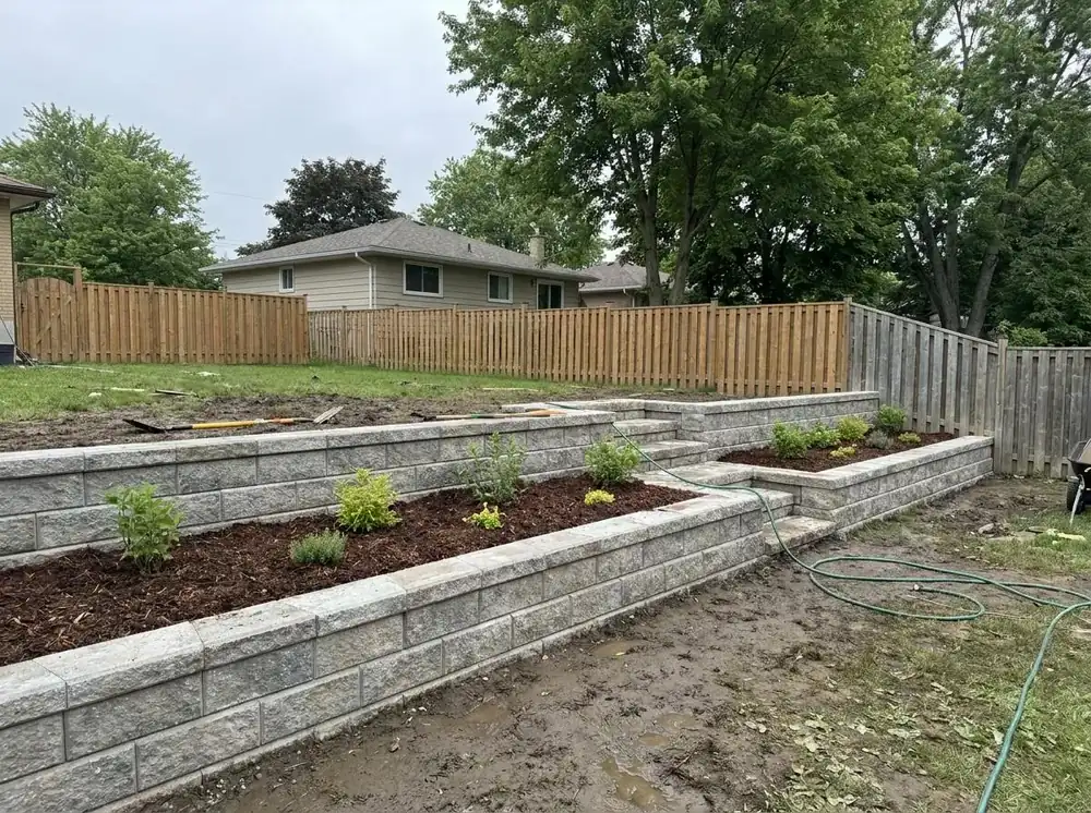 Tiered stone retaining wall with garden beds