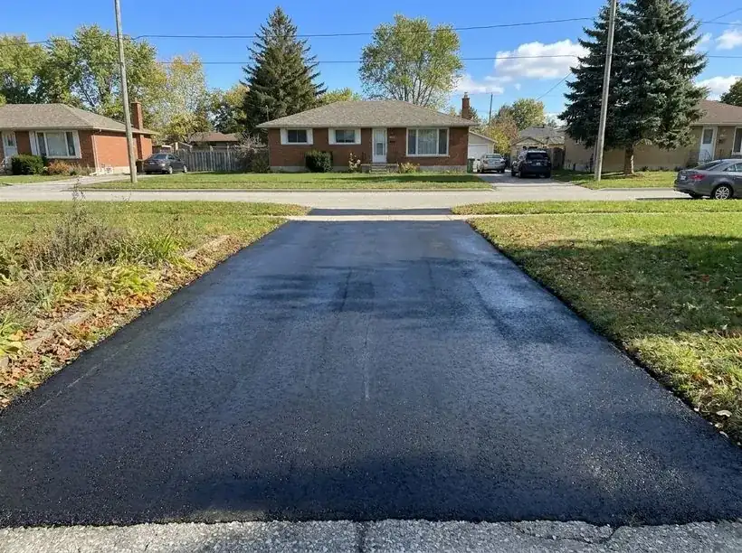 Freshly sealed black asphalt driveway after sealing