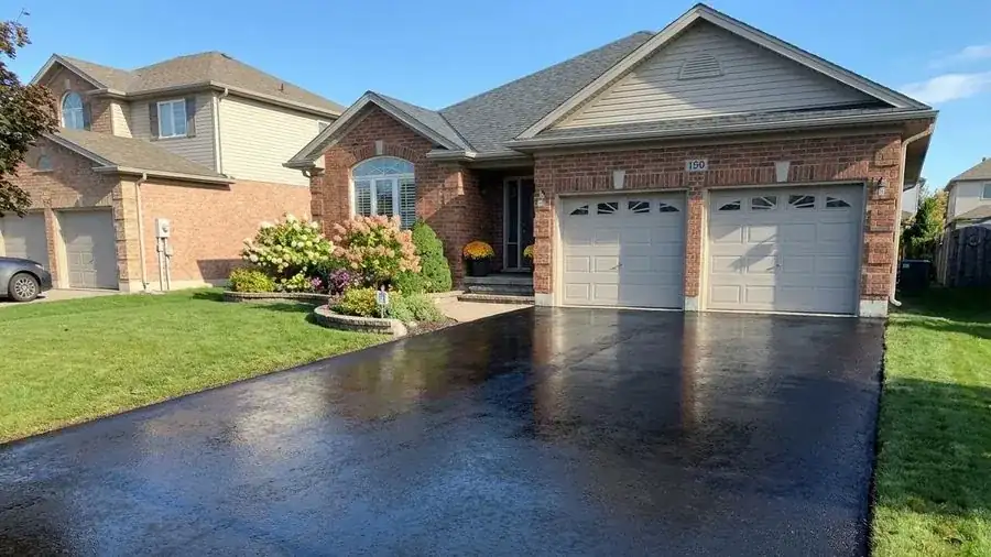Glossy freshly sealed double asphalt driveway