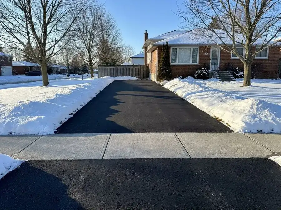 Cleared residential driveway after snow removal in winter