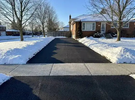 Cleared snowy driveway in winter